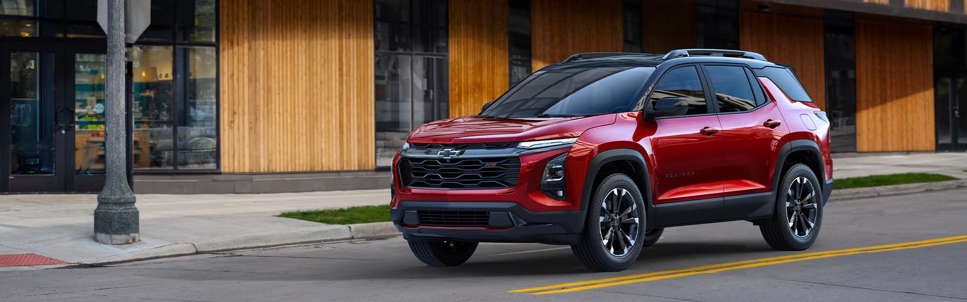 A red 2025 Chevrolet Equinox SUV parked.